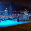 A concert with many people in blue light at the New year's Eve in Rome