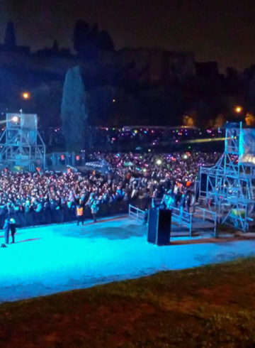 A concert with many people in blue light at the New year's Eve in Rome