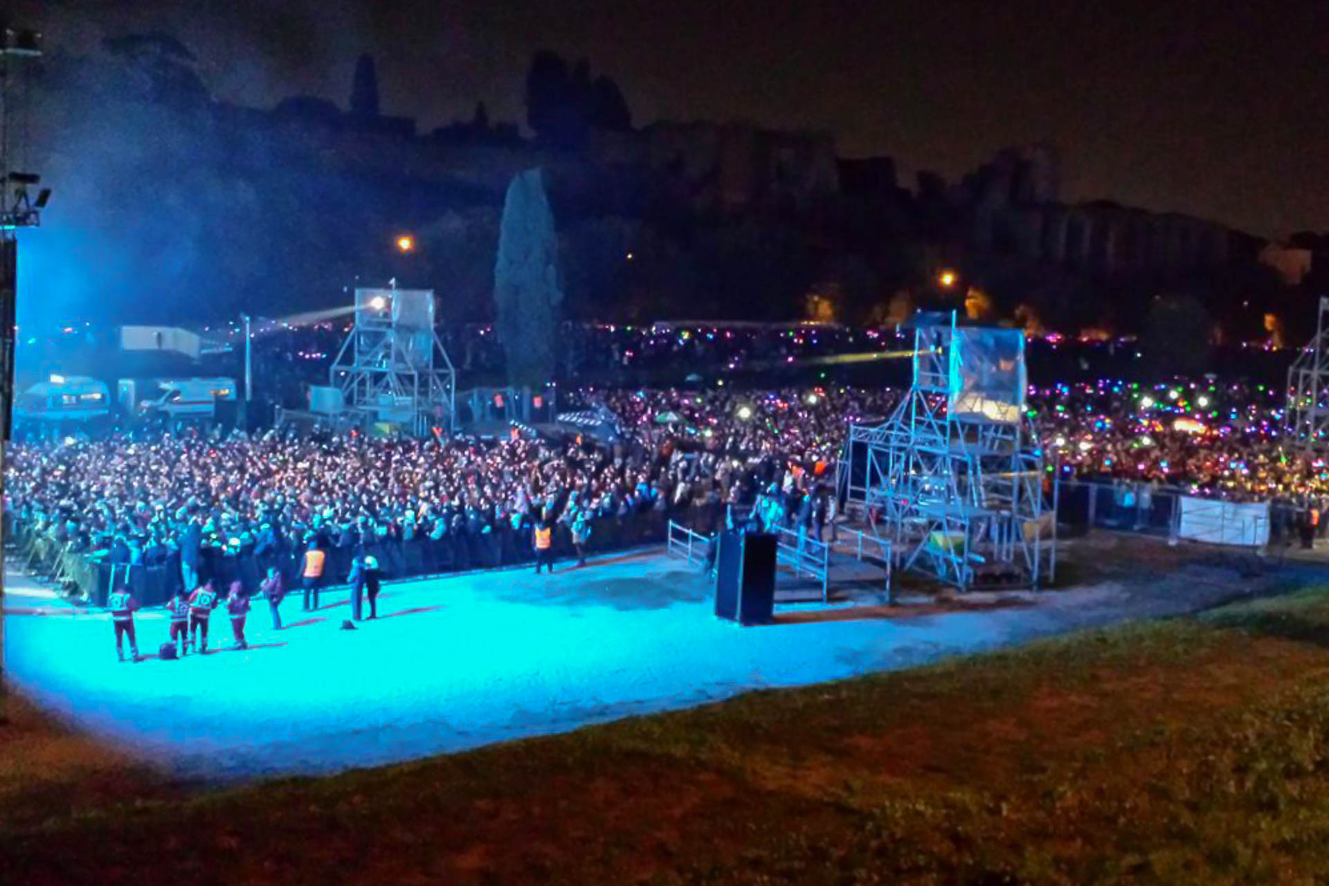 A concert with many people in blue light at the New year's Eve in Rome