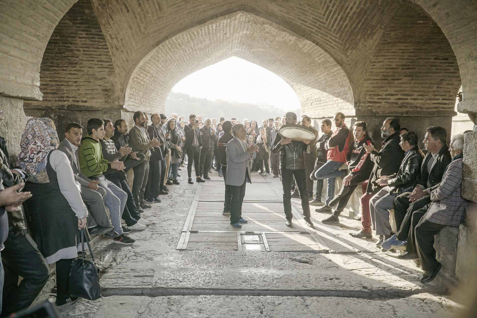 People dancing in a circle under the bridge in Isfahan