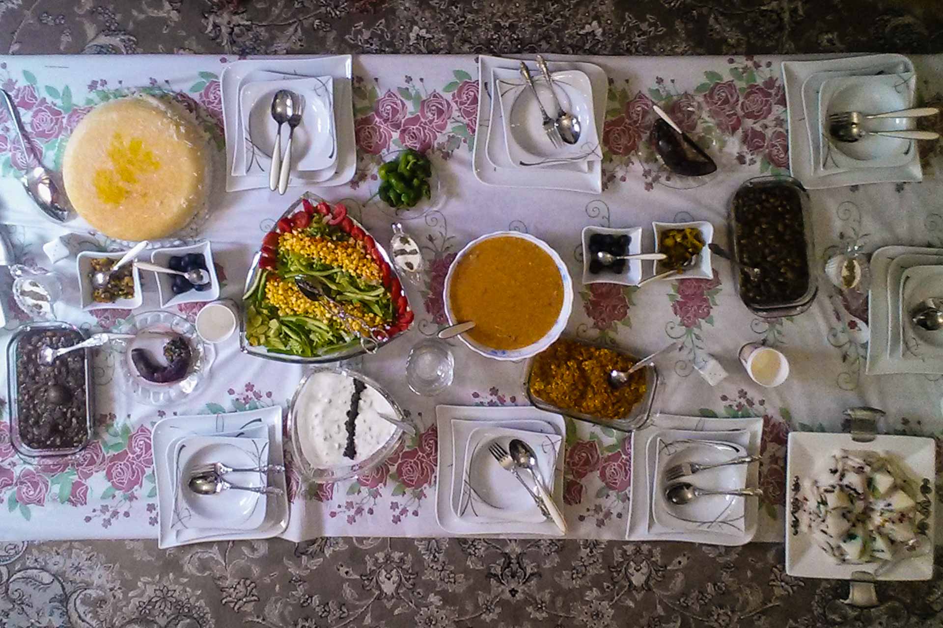 table set with plates and iranian dishes