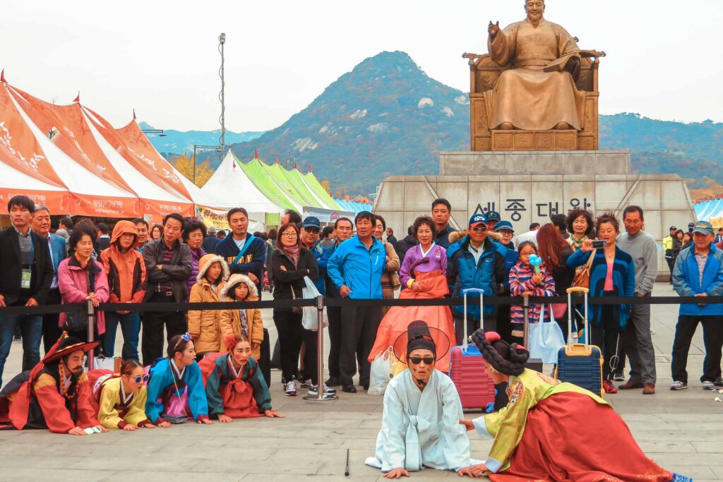 Group of people watching artists doing a theatre in Seoul, South Korea