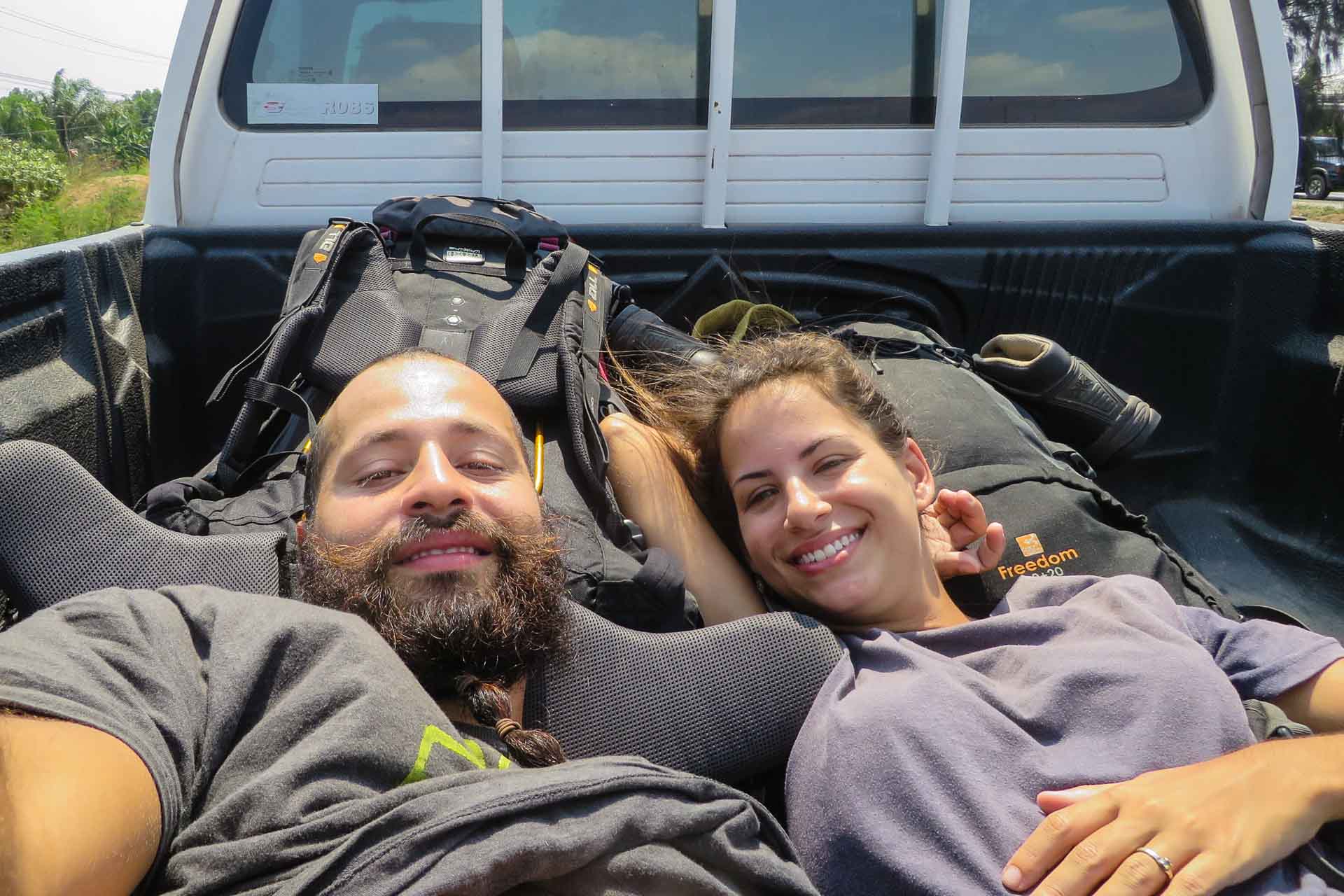 Fernanda and Tiago in the back of a pickup in Thailand hitchhiking when we were backpacking Thailand on a budget