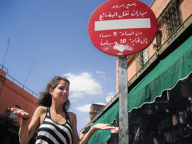 Fernanda looking at a sign in Morocco not understanding