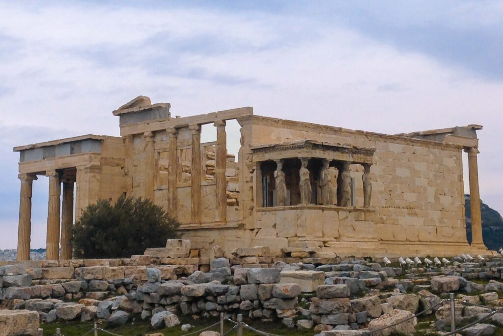 The acropolis in Athens with a typical greek construction in ruins