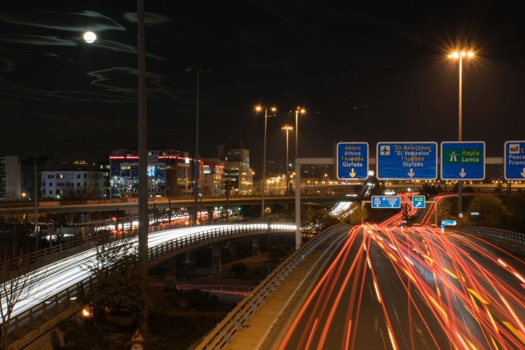 Athens at night with cars passing in the main avenue