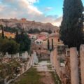 ruins in Athens with the Acropolis on top of the hill in the background