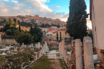 ruins in Athens with the Acropolis on top of the hill in the background