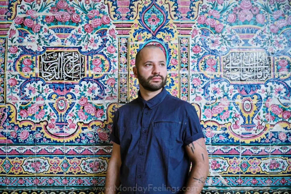 Tiago posing in front of a colourful wall in Shiraz, Iran