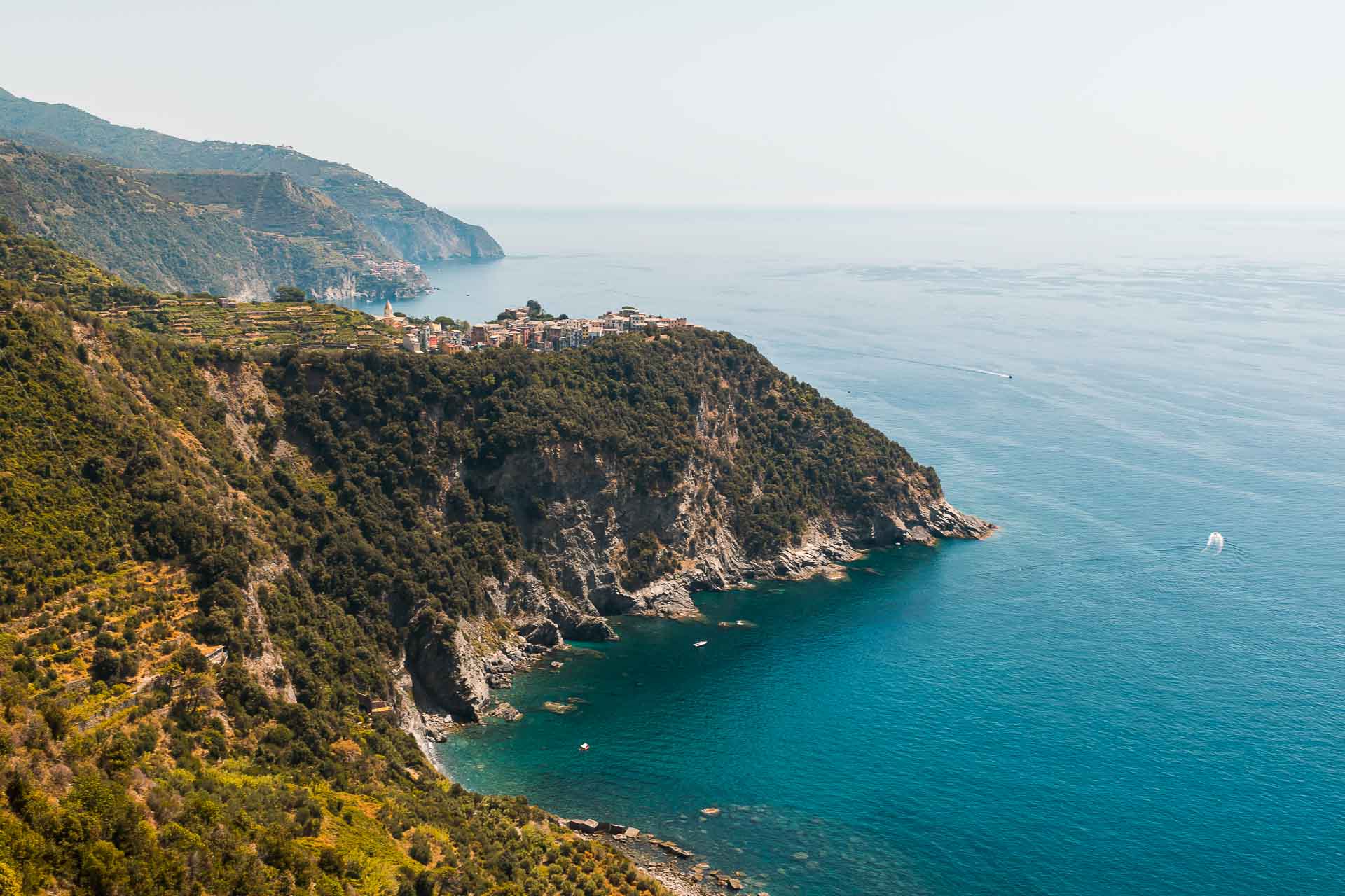 Overview of the Cinque Terre with a village on top of the mountain and the sea