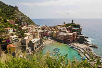 View of Vernazza in Cinque Terre from above the mountain with the beach and the village