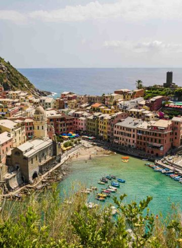 View of Vernazza in Cinque Terre from above the mountain with the beach and the village