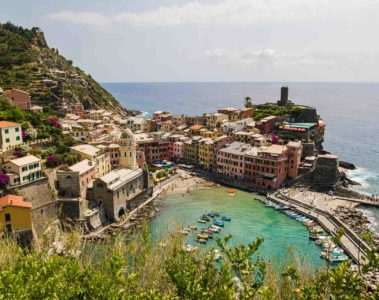 View of Vernazza in Cinque Terre from above the mountain with the beach and the village