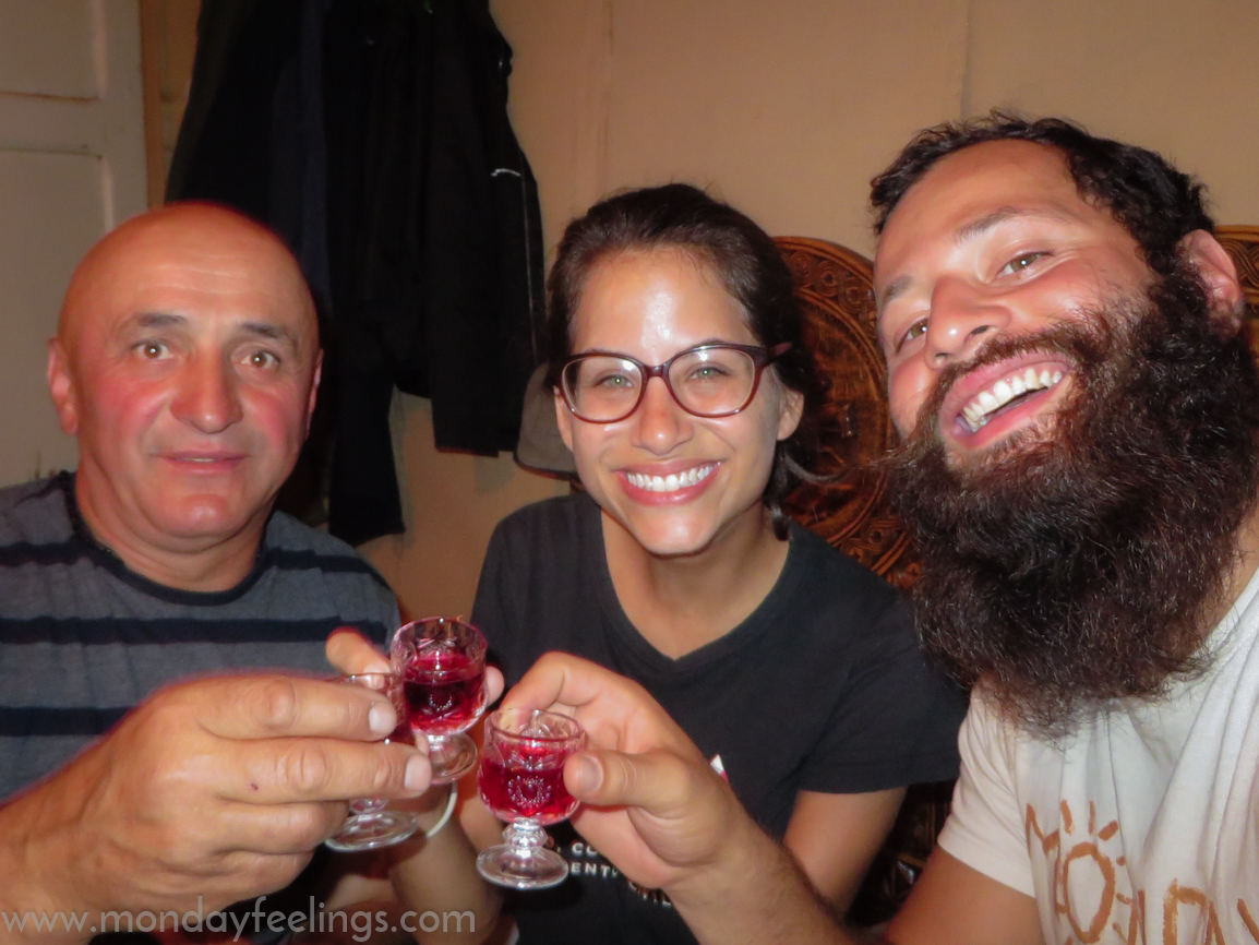 A Georgian, who does not speak English and Fernanda and Tiago, who don't speak Russia, drinking in Georgia