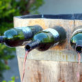 A wine fountain in Italy with wine coming out of bottles