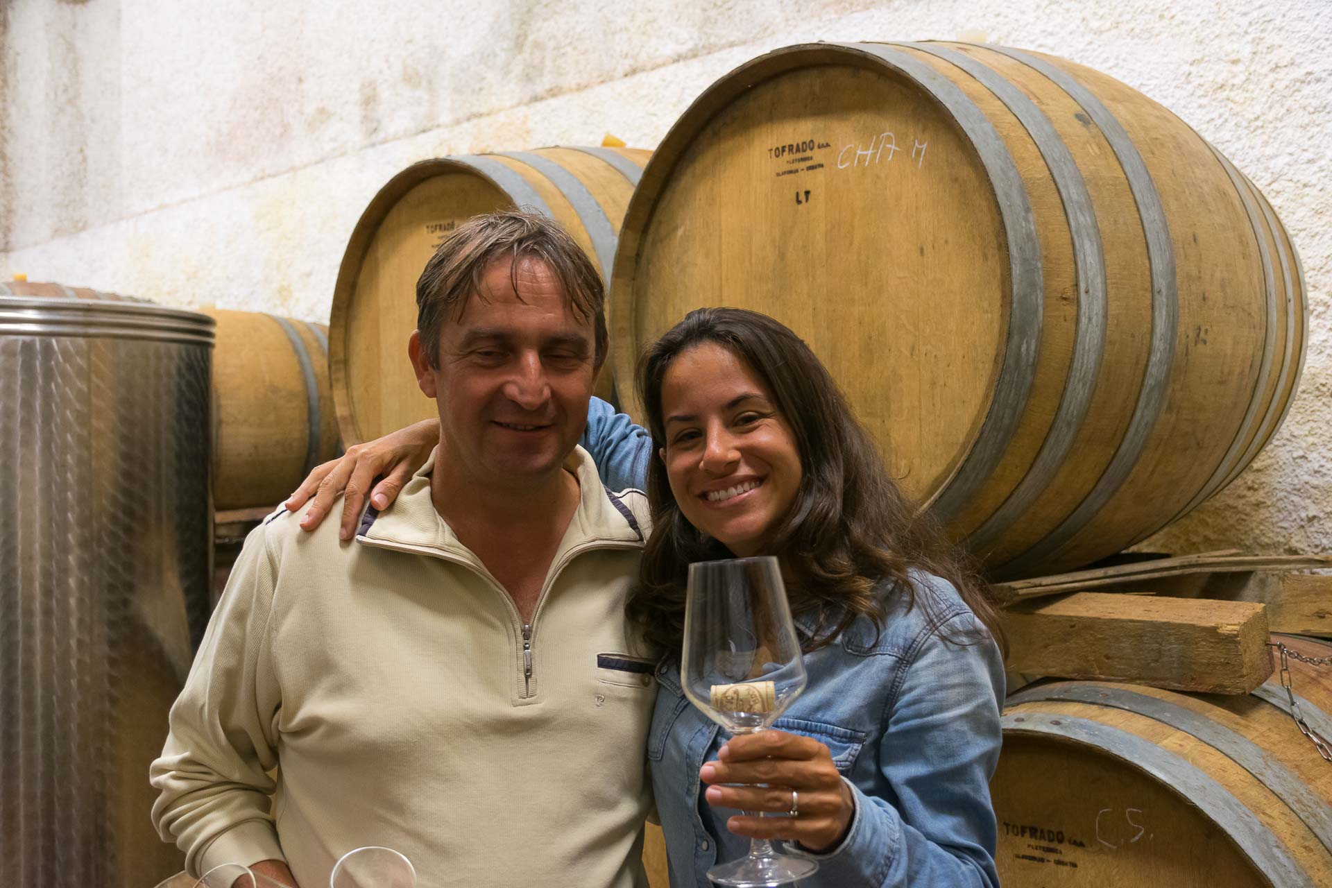Fernanda holding a glass of wine with the wine maker in Brda Slovenia