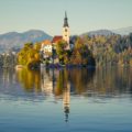 The little island in Lake Bled reflect in the water