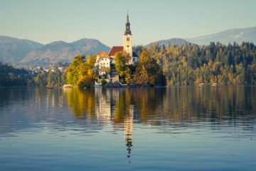 The little island in Lake Bled reflect in the water