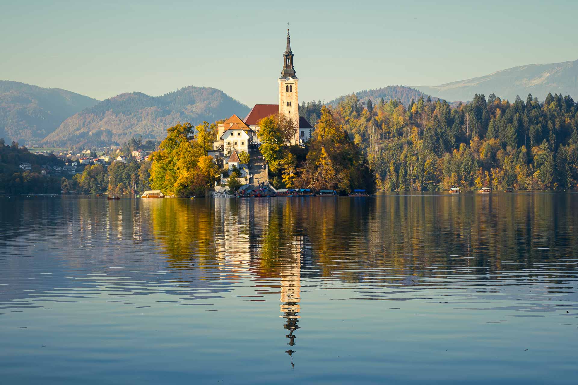 The little island in Lake Bled reflect in the water