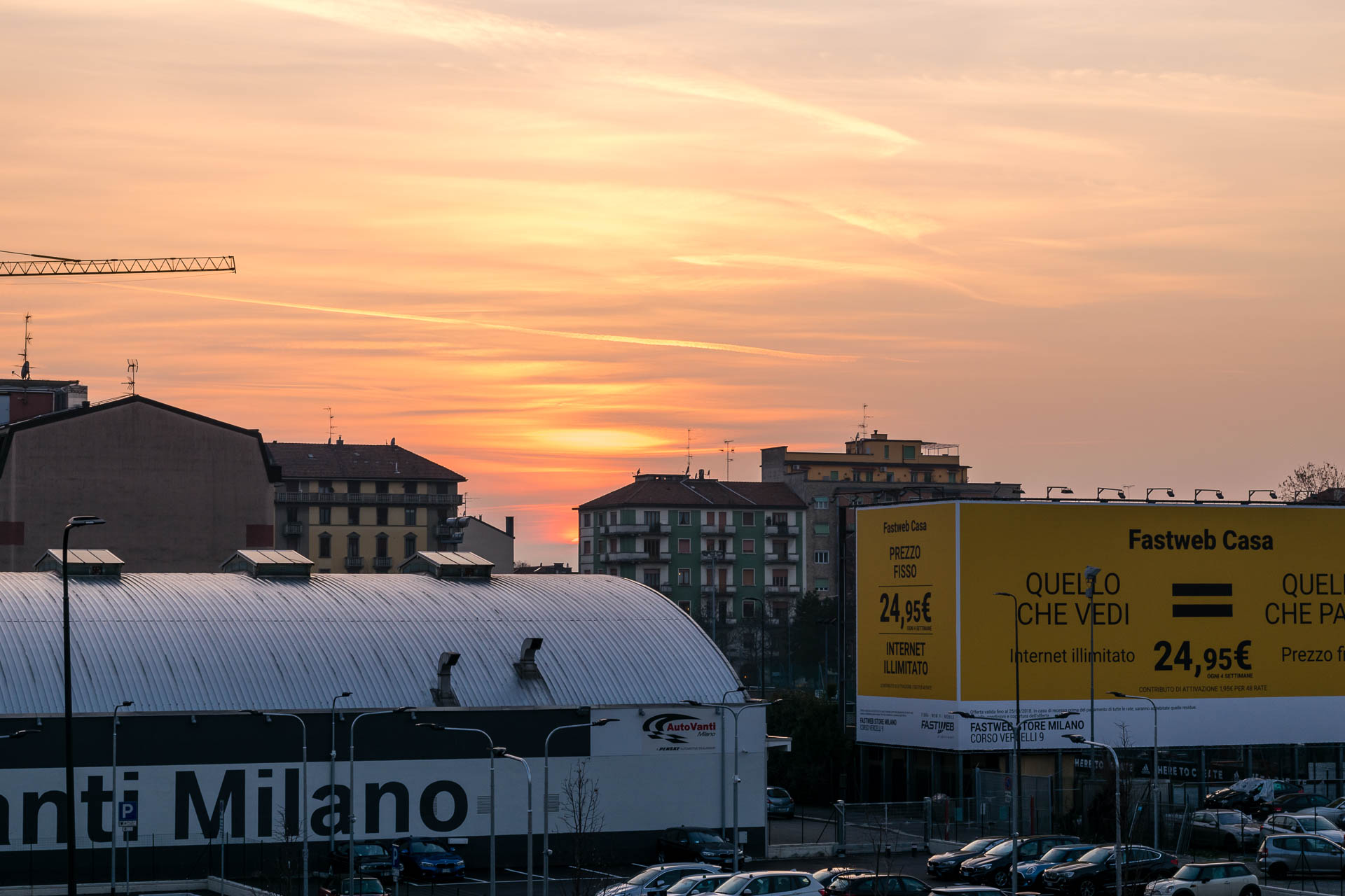 The sunsetting in the horizon in front of the entrance of BIT Milano