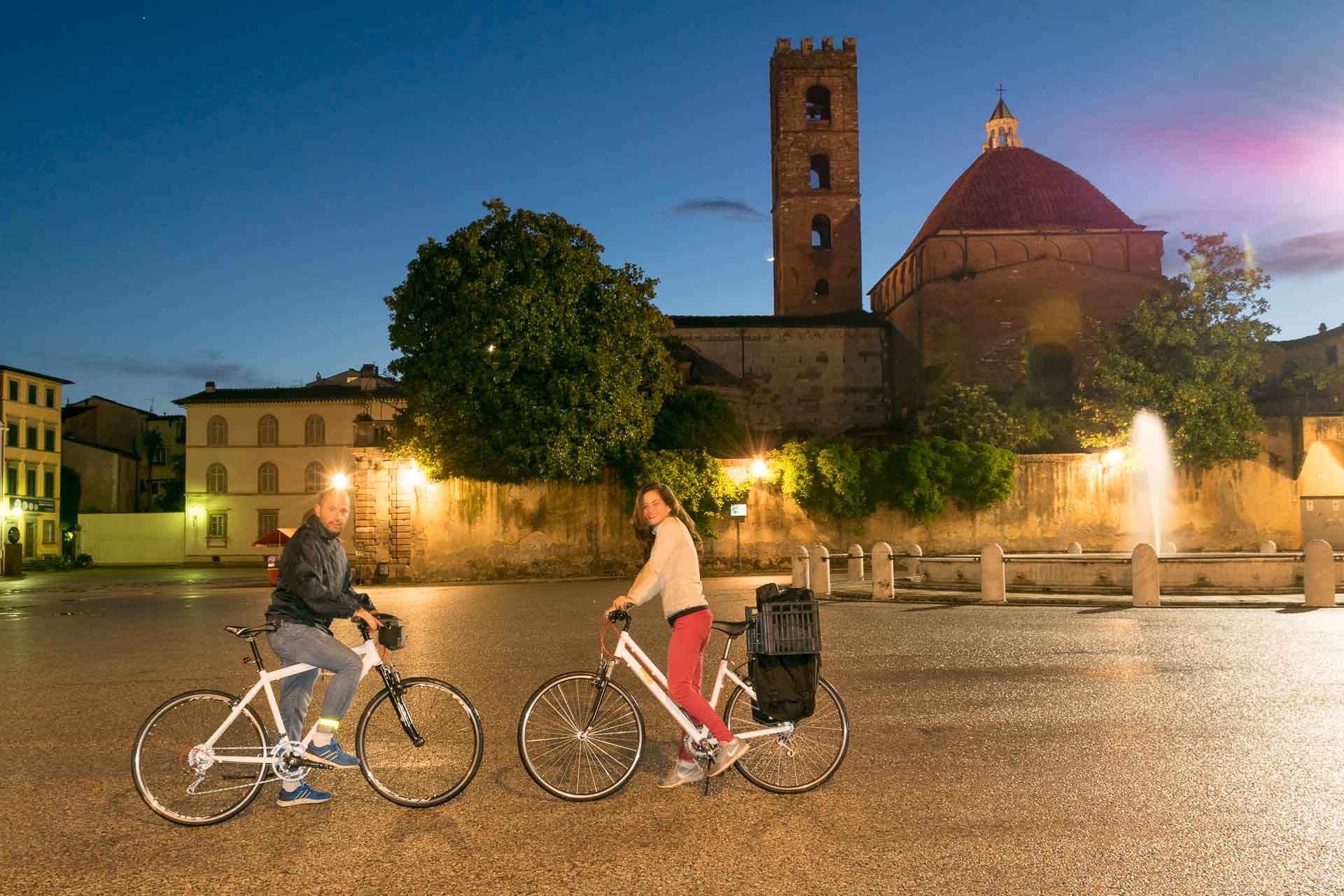 Tiago e Fernanda no centro de Lucca a noite com suas bicicletas