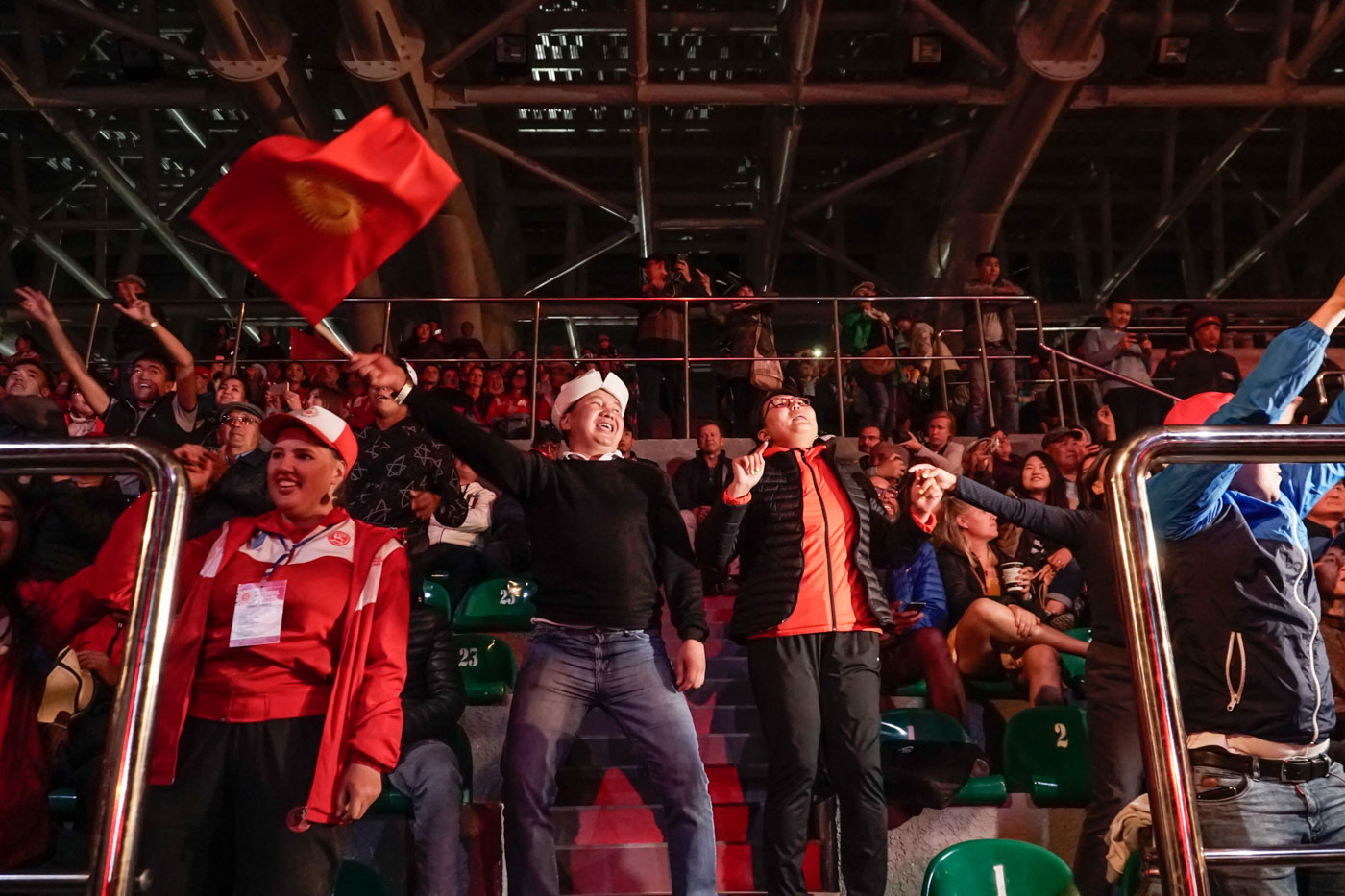 Man waving the flag of Kyrgyzstan during the world nomads competition