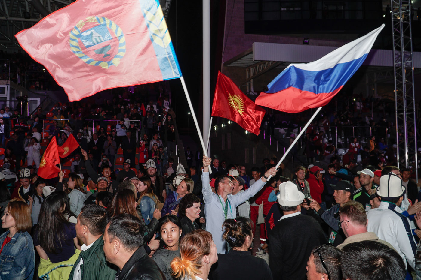 Man waving the flag of Russia and another in the middle of people