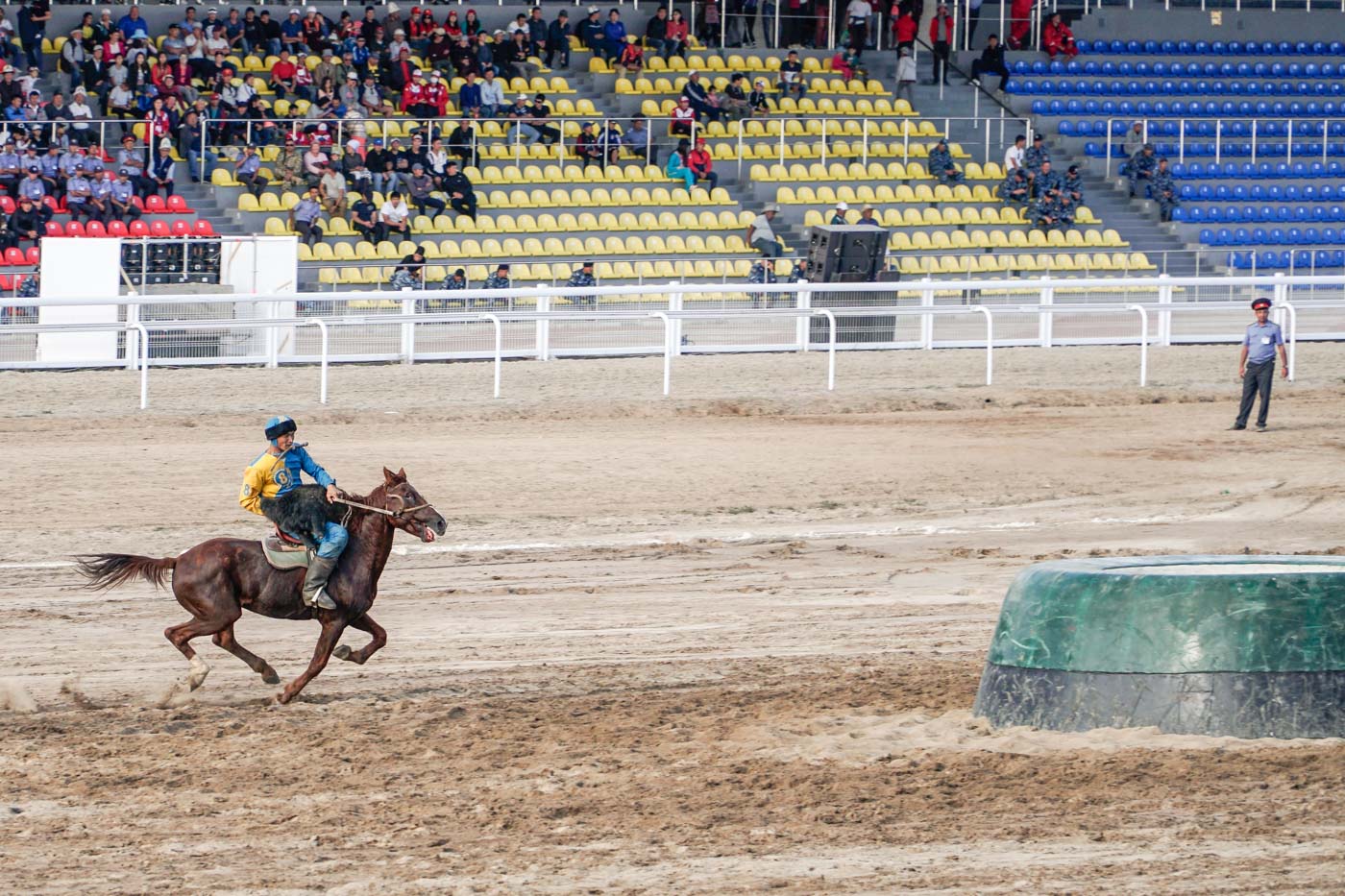 Man on horse about to throw the dead goat into the ring playing Dead Goat Polo known as Kok Buru at the World Nomad Games