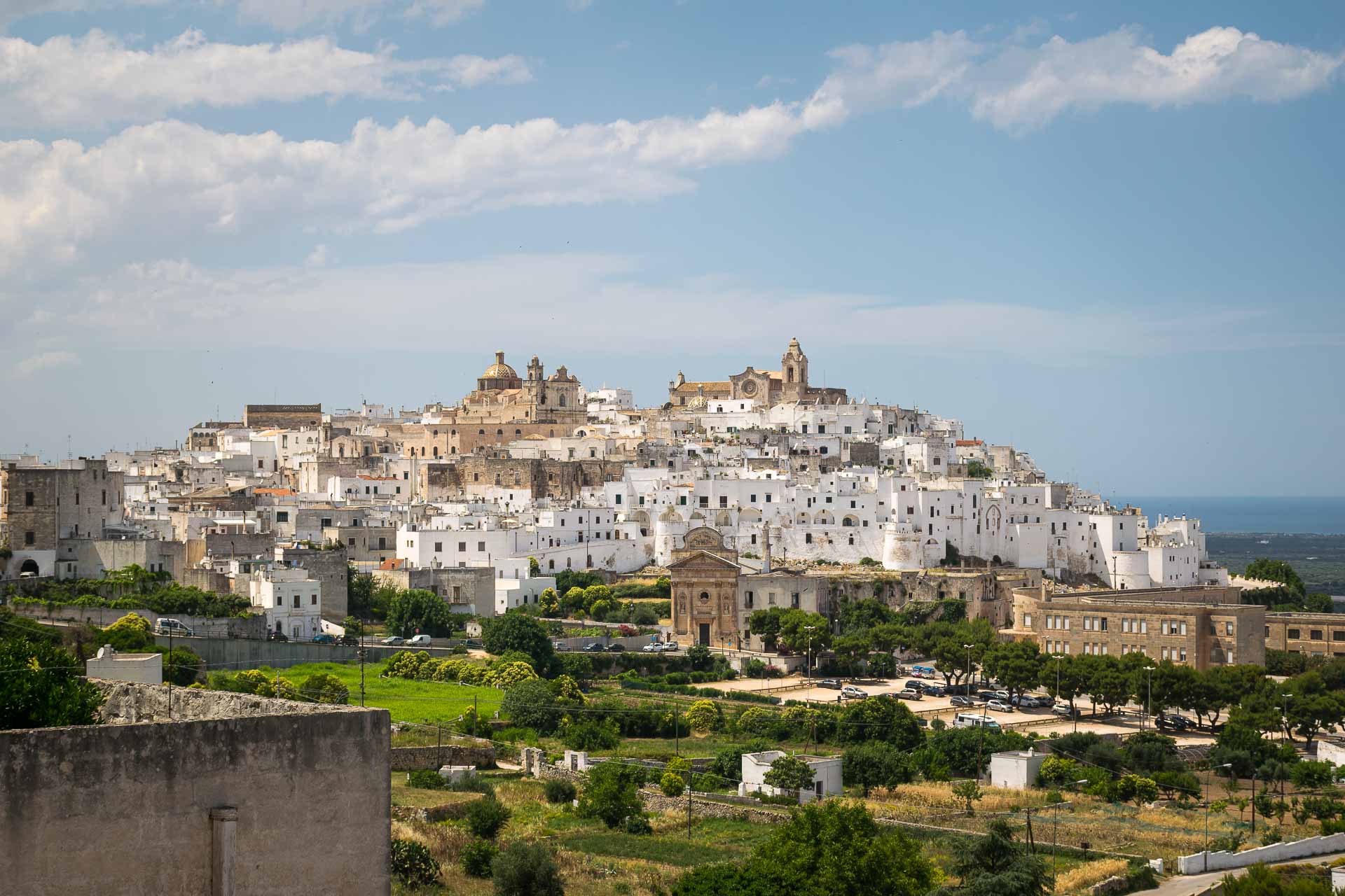 View of Ostuni with all the white houses on top of the mountain to include in you itinerary of Puglia
