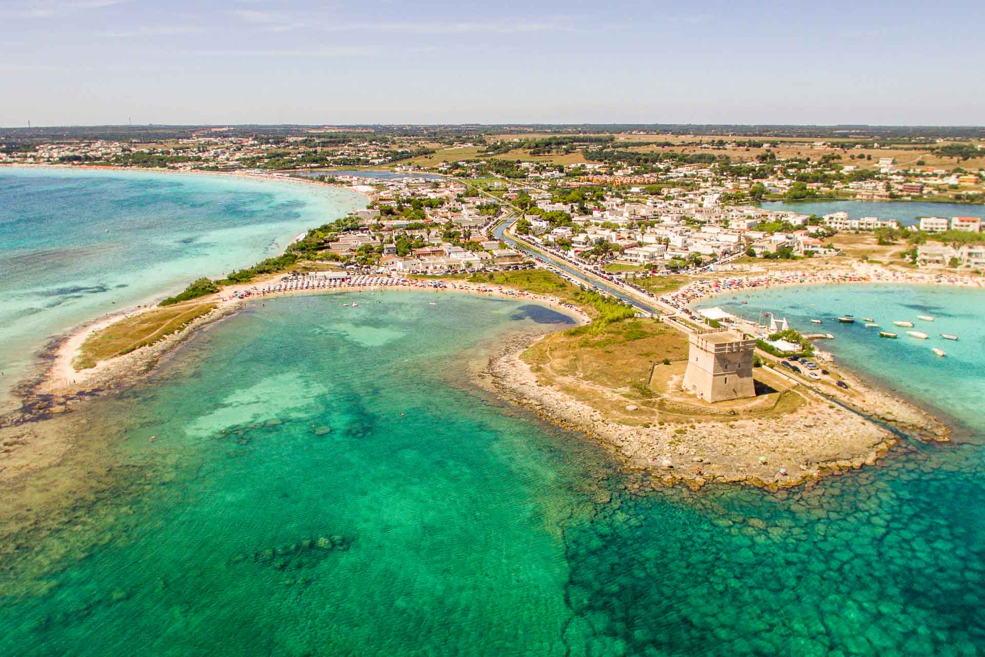 Aerial view of torre Chianca, an islet with a tower surrounded by crystal clear water