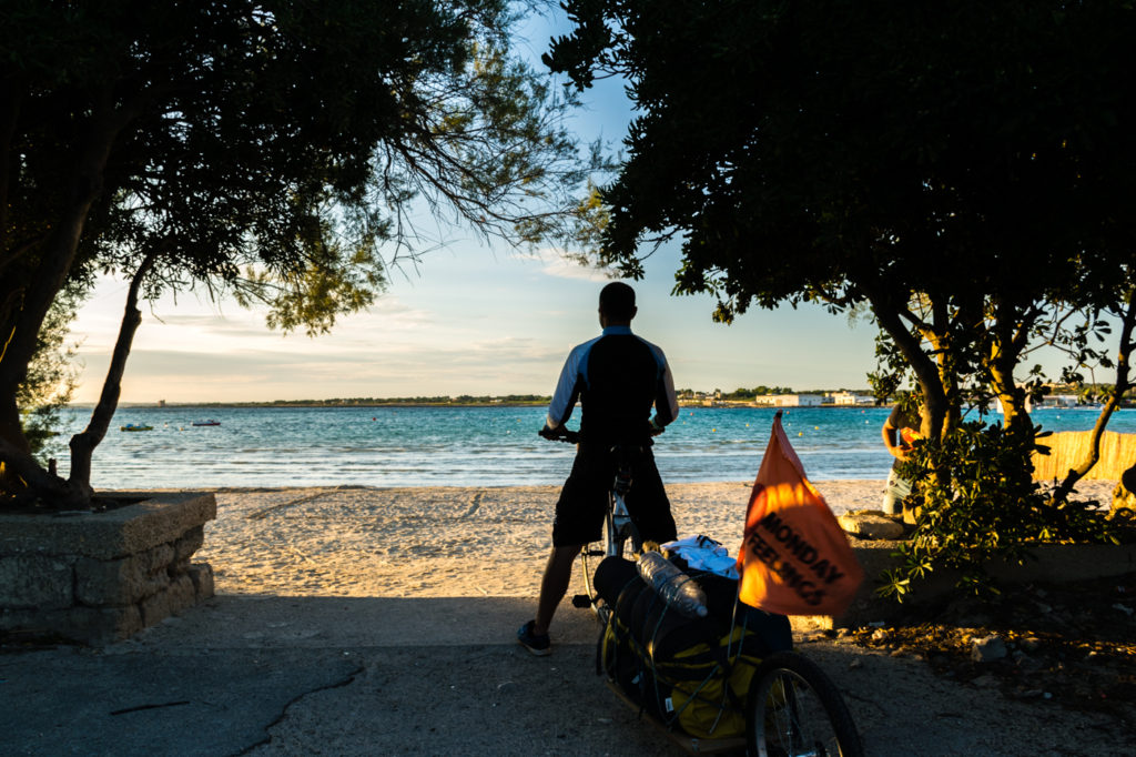 Puglia itinerary Tiago and his bike by the beach in Puglia