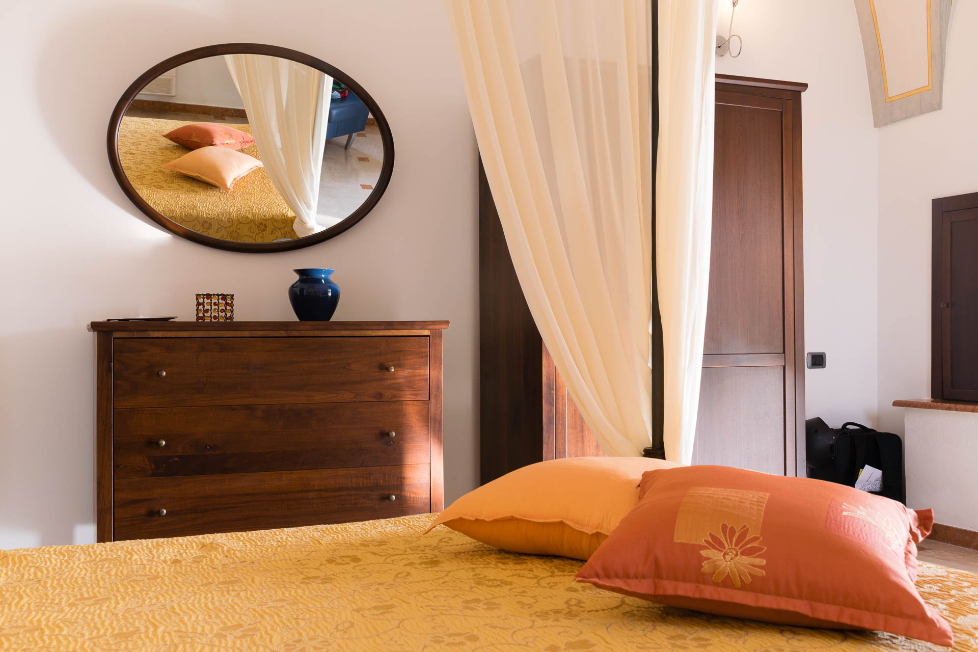 A view from the bed looking at a mirror reflecting the bedroom of La Baronessa Masseria