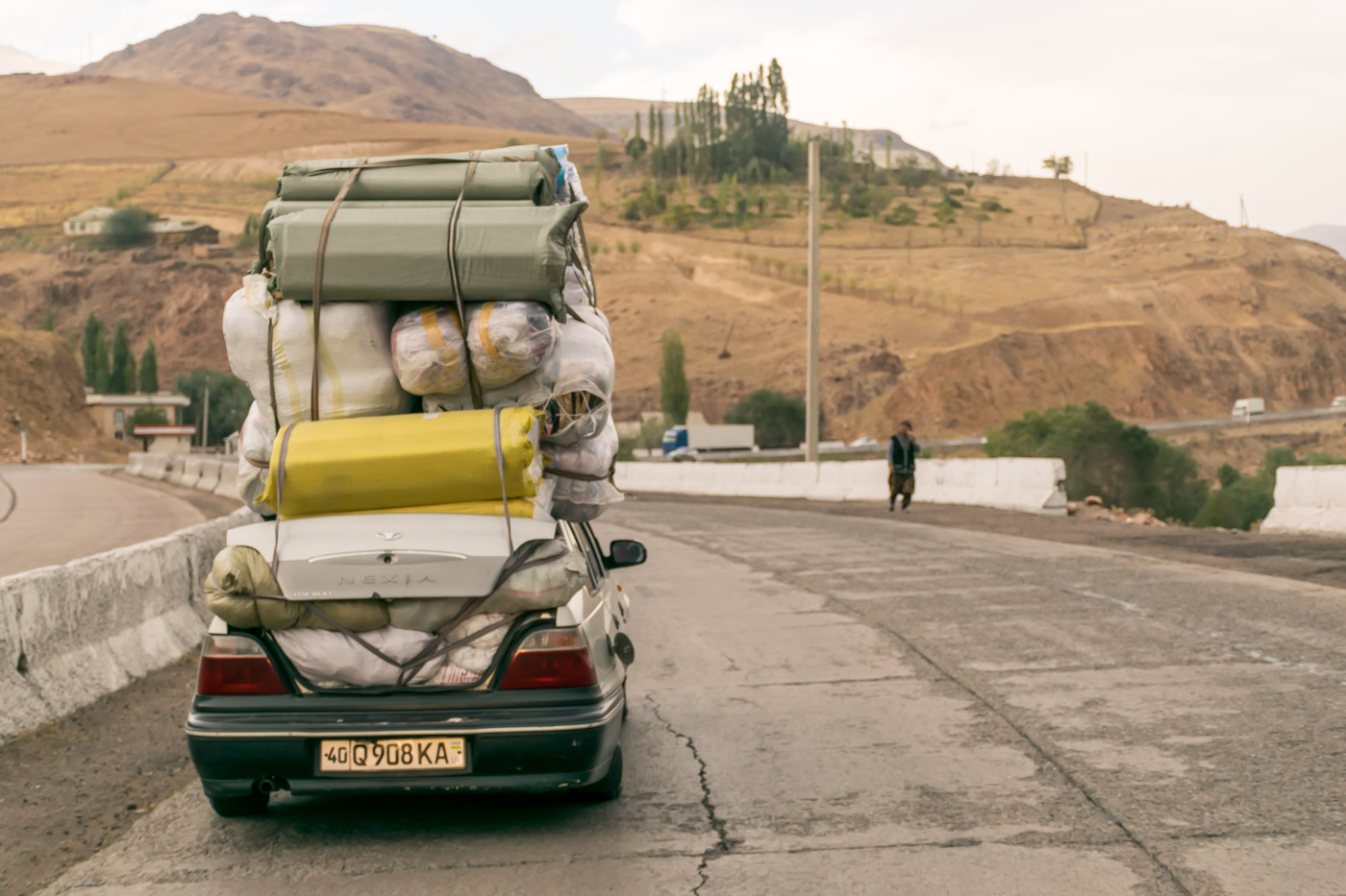 A car packed with things three times higher than the car driving in Kyrgyzstan