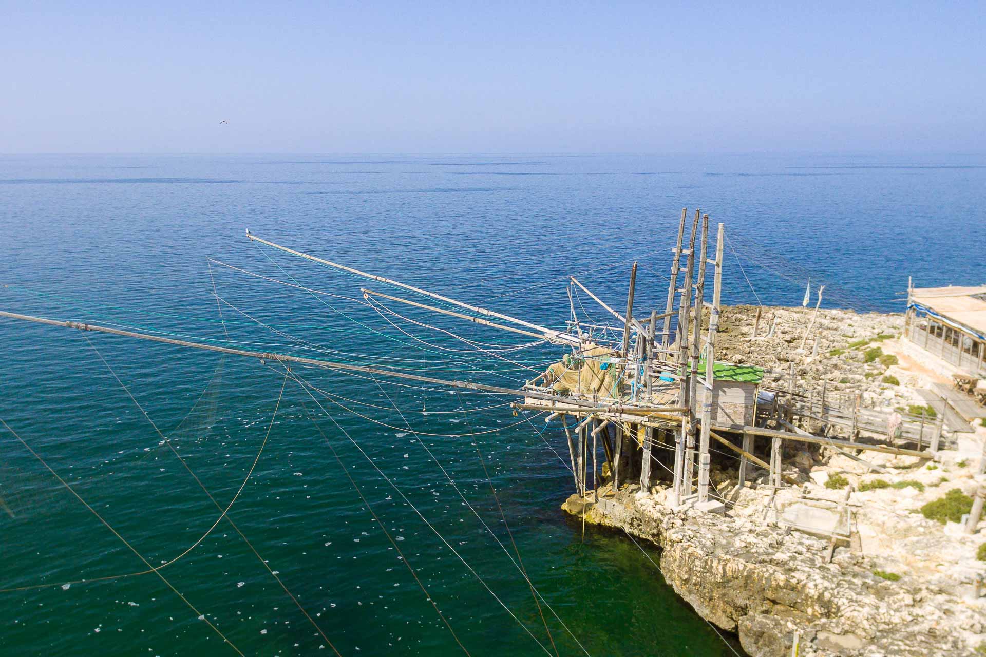 A trabuccho by the rock and a large blue sea of the Gargano in Puglia