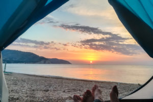 Gargano Puglia Sun rising in the sea horizon seen from our tent by the beach
