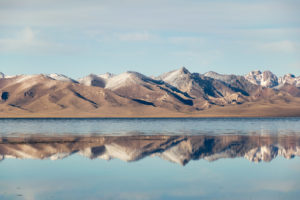 Kyrgyzstan tourist attractions Mountains in Kyrgyzstan reflected in the lake in the mirror effect