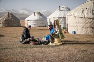Kyrgyzstan tourist attractions Tiago, Fernanda and a man building a fire in Kyrgyzstan