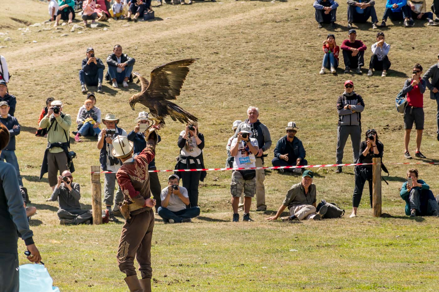 man holding and eagle at a presentation during the world nomad games