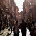 People walking against the sun light in the streets of Naples