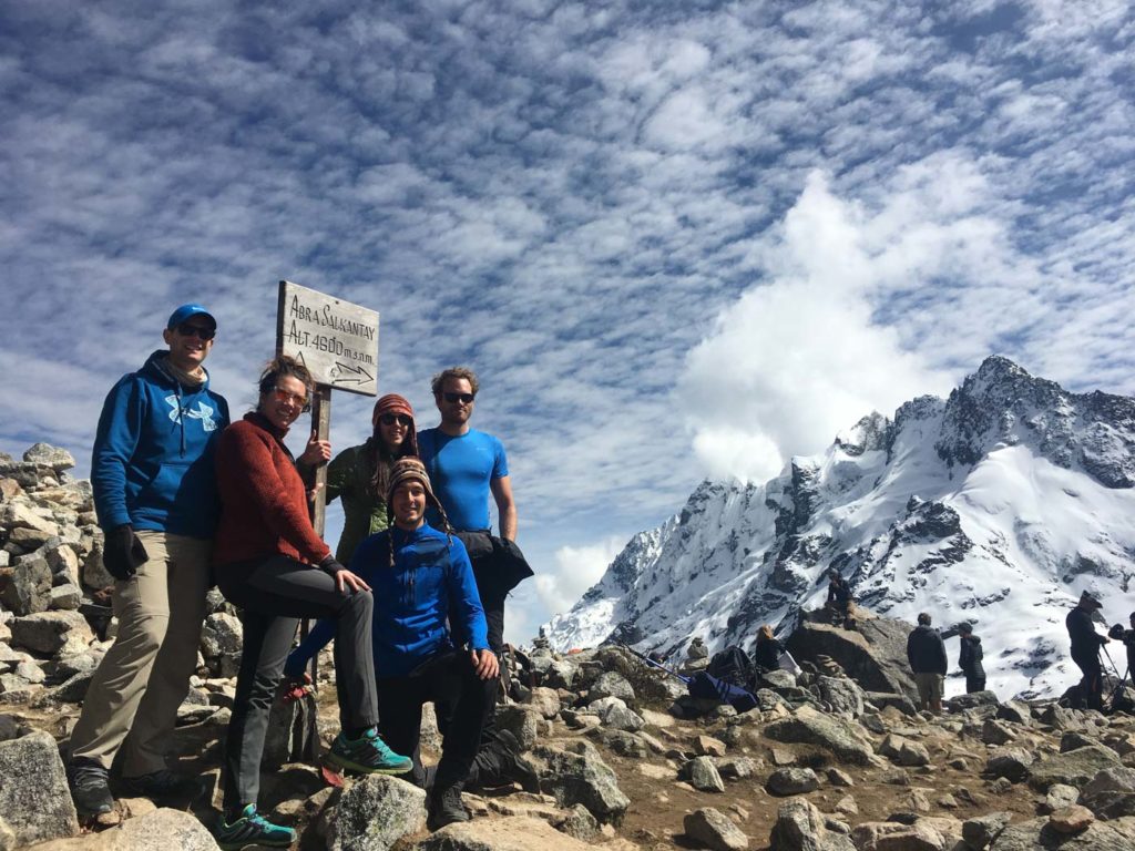 Trekkers reaching the top of the Salkantay mountain on their trek to Machu Picchu