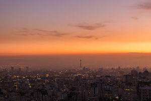 Overview of the city of Tehran with the sun setting colours and the tower standing out