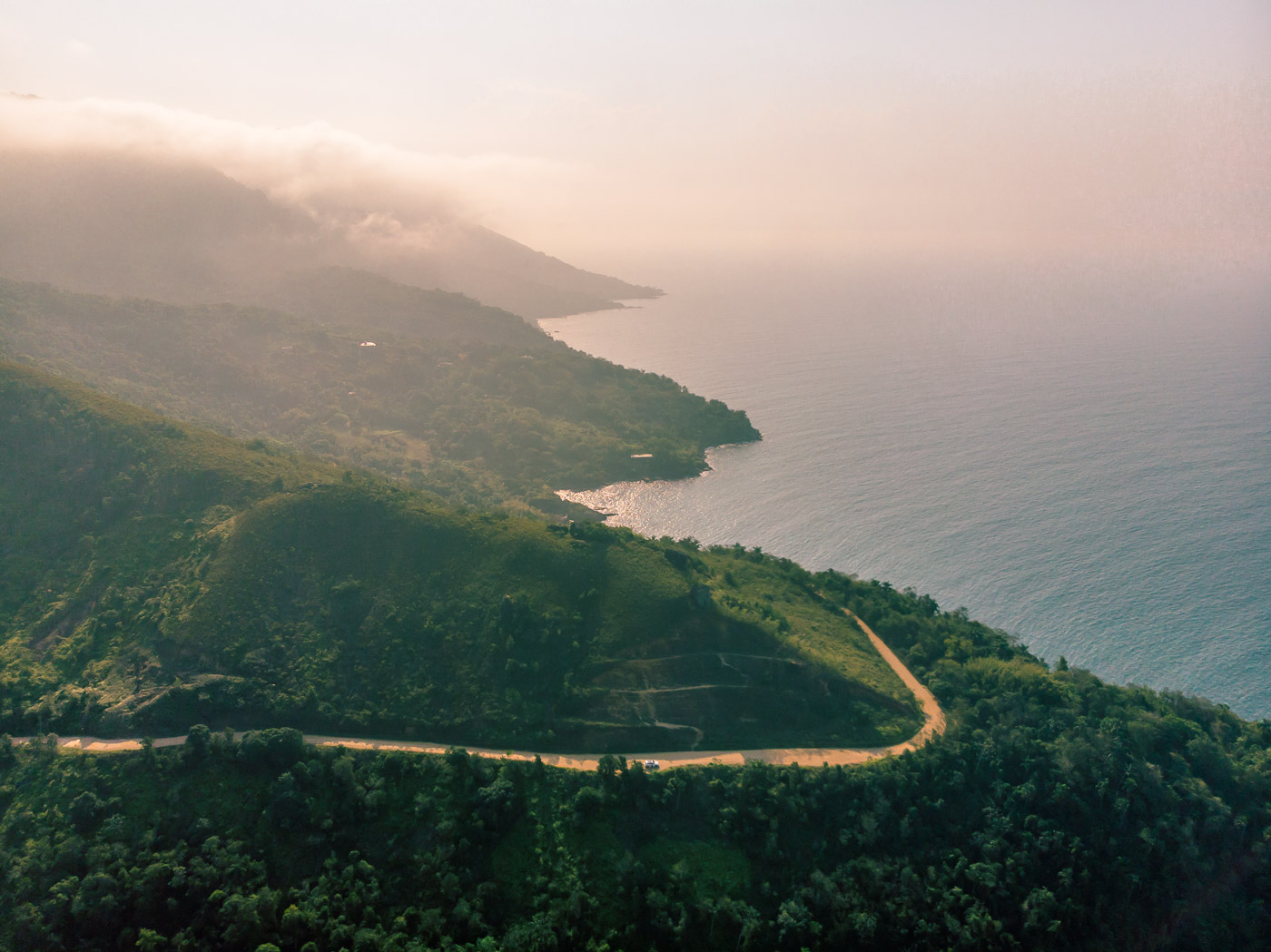 Aerial view of Ilhabela with a road crossing the mountain and the ocean on the side