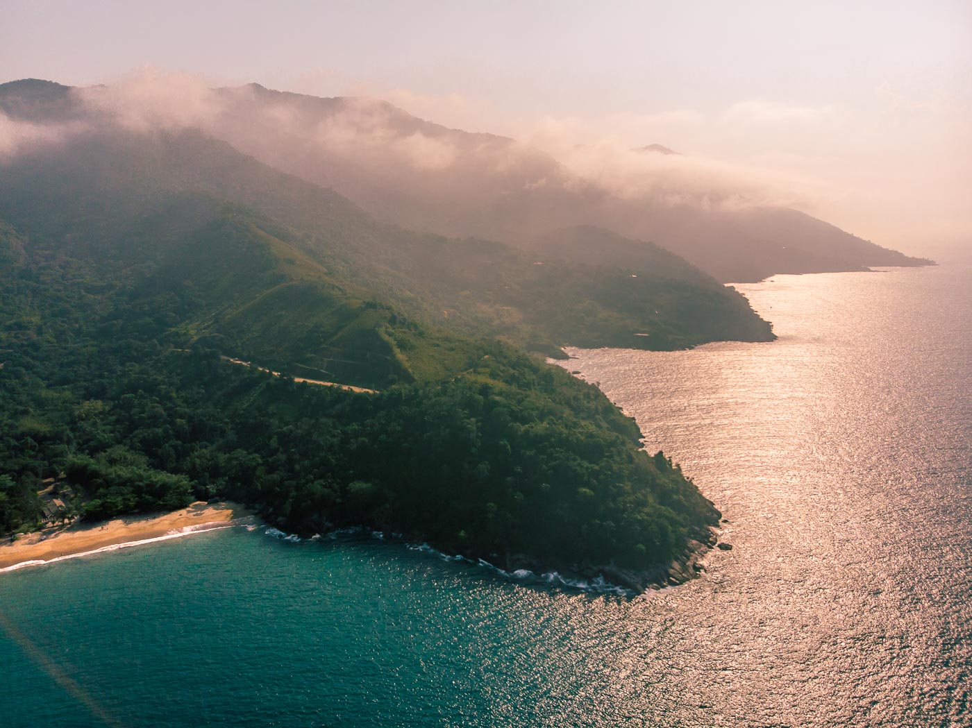 Aerial view of the coast of Ilhabela in Brazil with many mountains, the sea and the beach