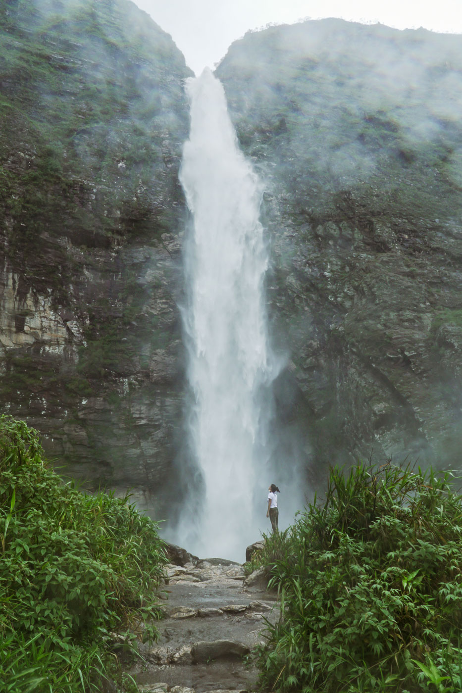 Fernanda in front of the massive Casca D'Anta Waterfall in Serra da Canastra Brazilian National Park