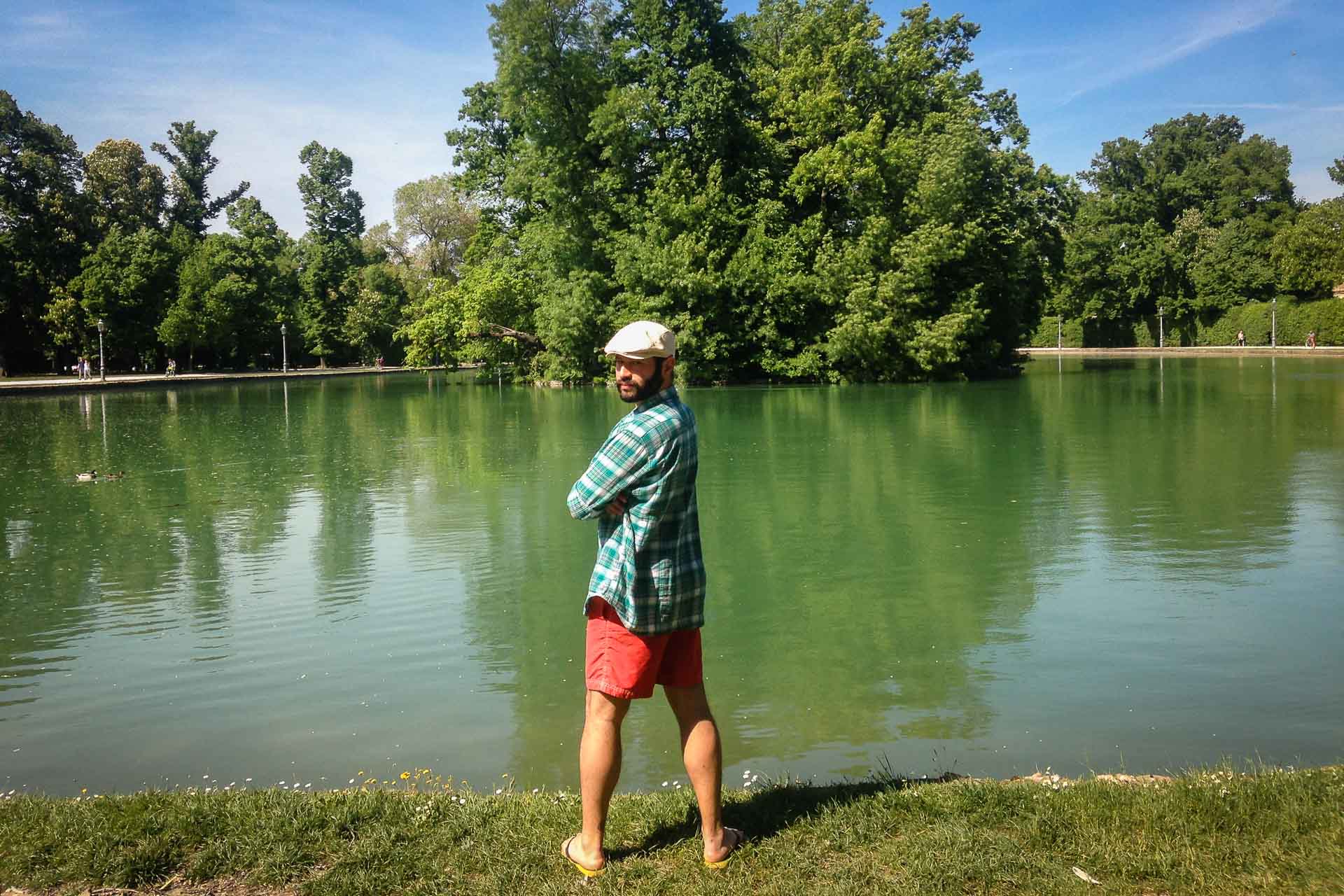 Tiago in front of a lake in the Parco Ducale in Parma, Italy looking to the camera