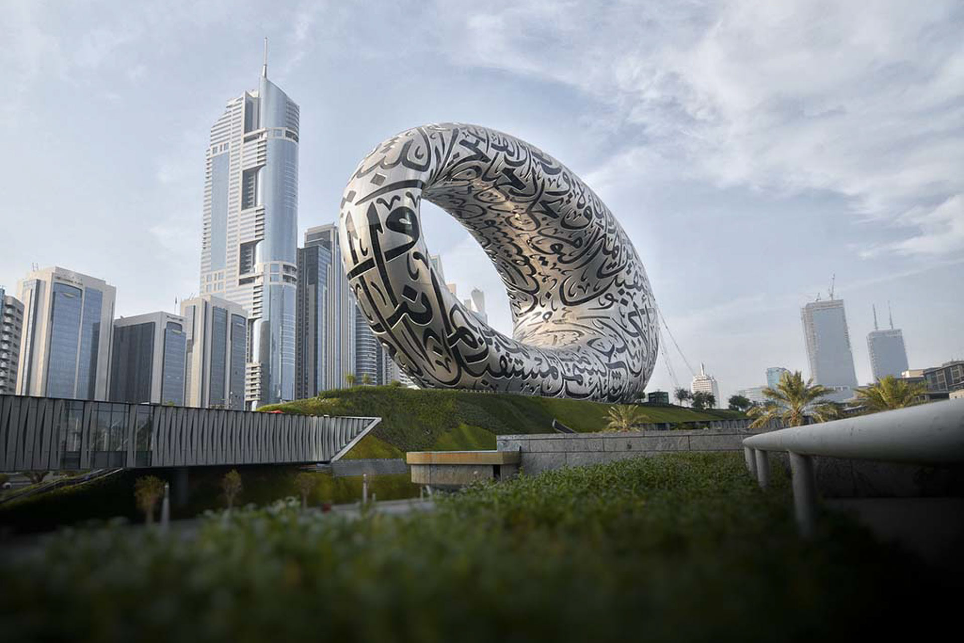 Outside view of museum of the future with large silver art work in front