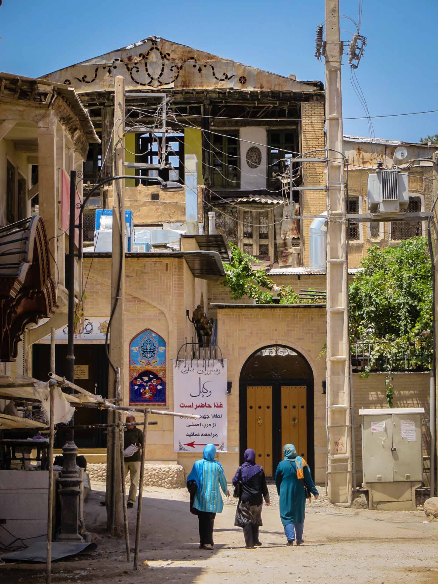 Three woman walking through the streets of Iran