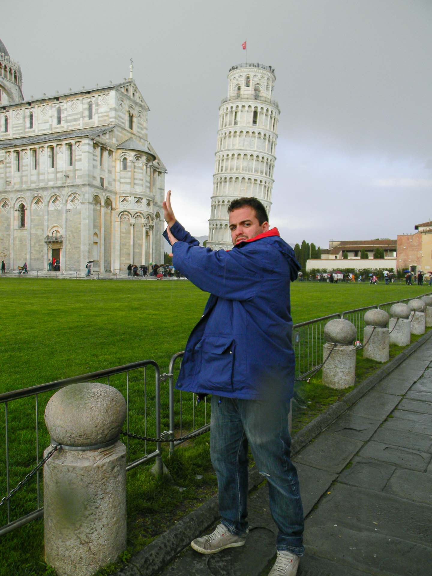 A man trying to hold the Pisa Tower but actually holding the church instead