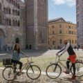 Tiago and Fernanda posing with their bike in front of the main cathedral of Parma