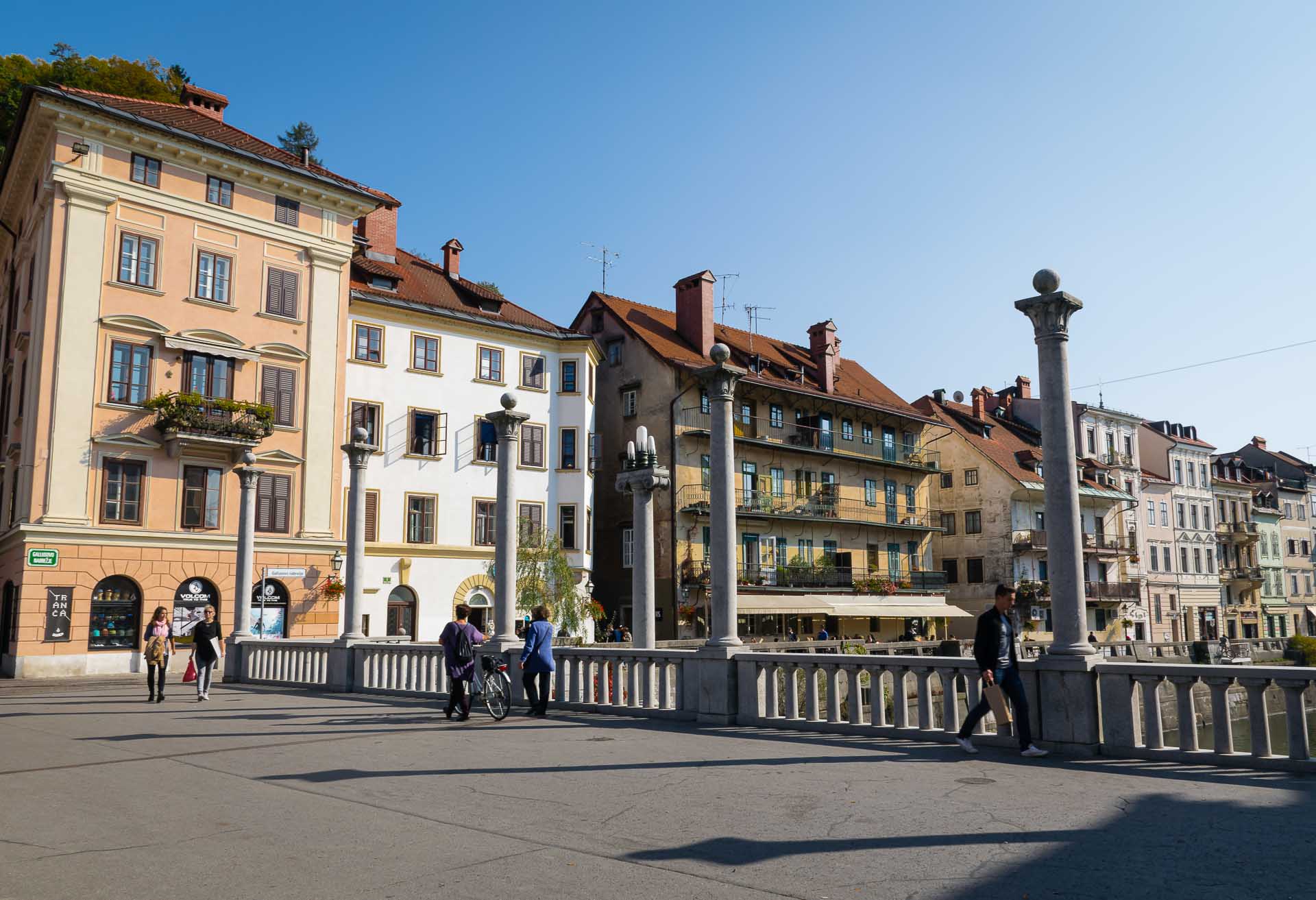 The Cobbler's Bridge in Ljubljana with a few people crossing it